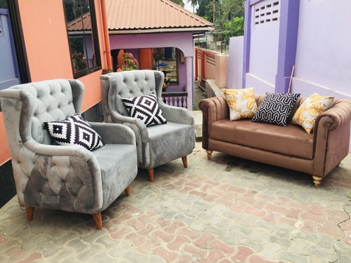 Grey arm chair and brown sofa